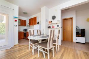 a kitchen and dining room with a table and chairs at Apartment Vidak in Vantačići