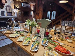 a table with plates of food on it at Hotel Protea Bolesławiec in Bolesławiec