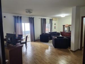 a living room with a couch and a table at HighLand suites in Aley