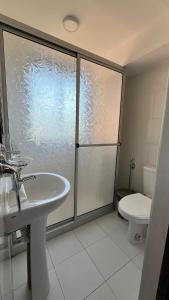 a bathroom with a shower and a sink and a toilet at Hotel Village Termas de Dayman in Termas del Daymán +126 photos