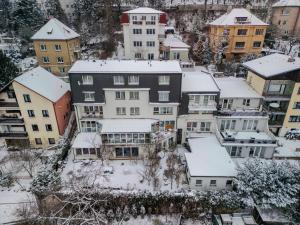a group of buildings with snow covered roofs at White House in Prague