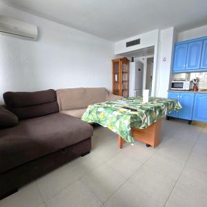 a living room with a couch and a table at Hilo Verde in Matalascañas +15 photos