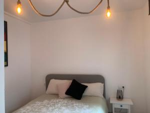 a bedroom with a bed with two pillows on it at Pals apartament centric in Pals
