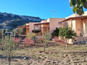 a house with trees in front of it at Anthos Residence 3 in Kefalos