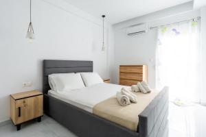 a bedroom with a bed with towels on it at Atrium The Living Experience in Malia
