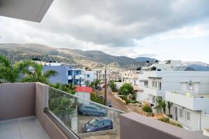 a balcony with a view of a city at Atrium The Living Experience in Malia