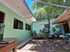 a room with a green wall with plants in it at Posada del Carmen 2 in Quillabamba