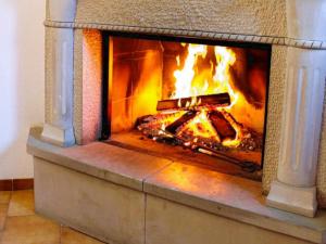 a fireplace with a fire inside of it at Baketxea, 8 PAX, Jardín, BARBACOA y Merendero in Elvillar