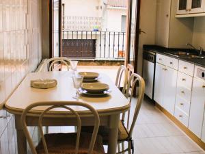 a dining room table with chairs and a table with glasses at Baketxea, 8 PAX, Jardín, BARBACOA y Merendero in Elvillar +32 photos