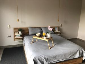 a bedroom with a bed with a table on it at Pikermi garden suite in Pikérmion +24 photos