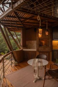 a wooden deck with a table and a tableablish at Satori Zen Club in Itauguá