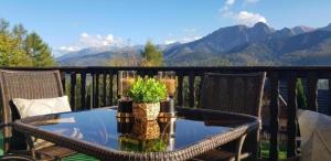 a table on a balcony with a view of mountains at Apartamenty Butorówka Dream 100m2 , Kościelisko - Zakopane in Kościelisko