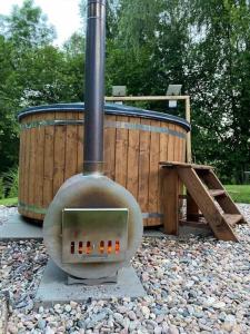 an outdoor stove is sitting on some rocks at Tiny Resort Chotěvice 2 in Chotěvice