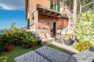 a backyard with a house with a patio at SEAHORSEROOM - Frontemare con Idromassaggio in Finale Ligure