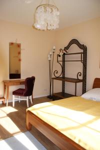 a bedroom with a bed and a table and a desk at Ferienhaus Lilli in Pruchten