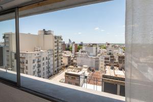 a view of a city from a window at Monoambiente amplio , moderno y super completo in Montevideo