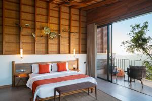 a bedroom with a bed and a balcony at Wishing Tree Boutique Resort and Spa - Haputale's Panoramic Hideaway in Haputale +60 photos