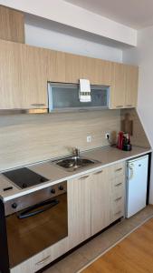 a kitchen with a sink and a counter top at Aspen Golf Resort Studio E206 in Bansko