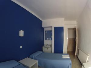 Postel nebo postele na pokoji v ubytování Hostal German