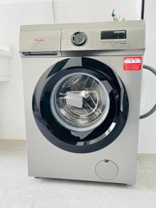 a white washing machine with its door open at Diamond Oark Residency in Gatunga