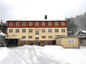 a large building in the snow on a snowy street at Waldhaus zur Kleinbahn in Glashütte +7 photos