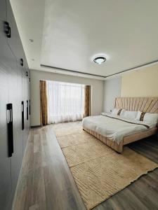a bedroom with a bed and a large window at Diamond Oark Residency in Gatunga +13 photos