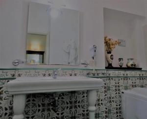 a bathroom with a sink and a mirror at B&B luxury San Giuseppe in Gerace