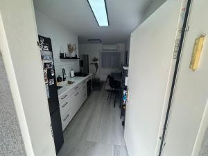 a kitchen with a refrigerator and a kitchen table at הבית של גיא בנאי in Beer Sheva