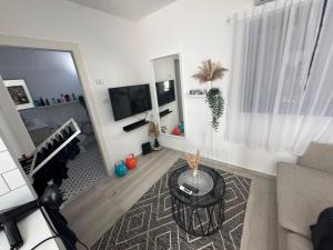 a living room with a couch and a flat screen tv at הבית של גיא בנאי in Beer Sheva +4 photos