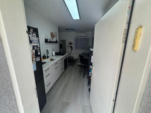 a kitchen with a refrigerator and a kitchen table at הבית של גיא בנאי in Beer Sheva