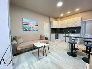 a living room with a couch and a kitchen at NJ Collection in Varna City
