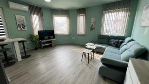 a living room with a couch and a table at NJ Collection in Varna City