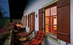 a patio with chairs and a table and a window at Bauernhof Berndlhof Obing in Obing