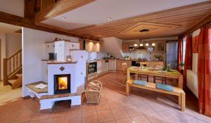 a kitchen with a fireplace in the middle of it at Bauernhof Berndlhof Obing in Obing