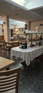 a table with a white table cloth on it in a room at Continental Hotel in Miramar