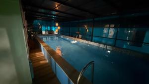 a large swimming pool in a building at Mayooram Back water Pool Villa in Kollam +16 photos