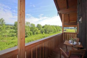 a view from the porch of a cabin with a table and chairs at Schauerhof in Chieming