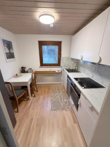 a kitchen with a table and a dining room at Sunroom 2 Bed Apartment West Town B17 in Heidenheim an der Brenz +9 photos