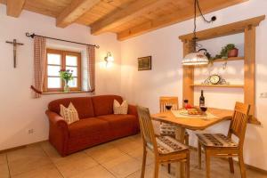 a living room with a couch and a table at Schauerhof in Chieming