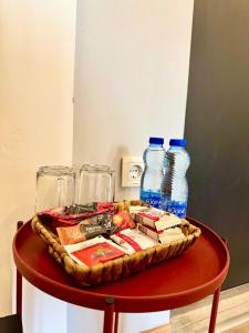 a table with a tray of food and two bottles of water at E - Central Room Two in Skopje