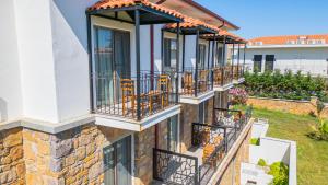 a house with balconies on the side of it at Otel Kefalos in Gokceada Town