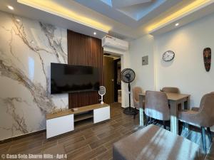 a living room with a flat screen tv on a wall at Casa Sole Sharm Hills Apt 4 in Sharm El Sheikh