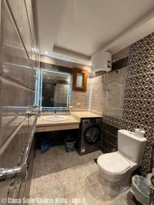 a bathroom with a toilet and a sink at Casa Sole Sharm Hills Apt 4 in Sharm El Sheikh +4 photos