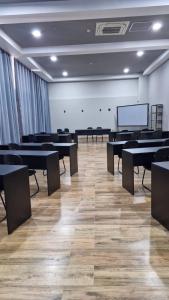 a large room with tables and a screen in it at Tulip Inn Bauru in Bauru +35 photos