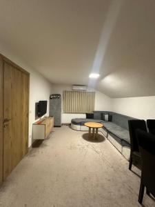a living room with a couch and a table at Apartments Aventra in Visoko