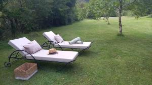 two lounge chairs and a table in a field at CHALET de la CHEVANNE in Laissey