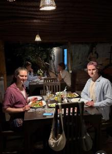 a group of people sitting at a table eating food at Coco Cabana Kite Resort Kalpitiya, closest to the kitesurfing point in Kalpitiya