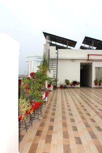 an empty rooftop patio with plants and chairs at Shagun Hotel & Banquet in Lucknow