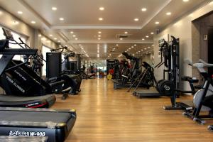 a gym with treadmills and elliptical machines at Shagun Hotel & Banquet in Lucknow