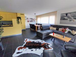 a living room with a couch and a table at Apartment Keller in Savognin